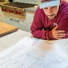 Man reading blue prints