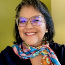 woman with glasses smiling